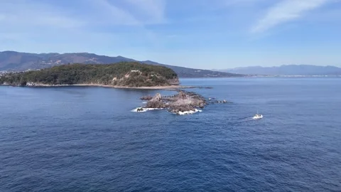 Fishing Boat Passing Manazuru Cape Rocks│Japan Aerial Stock Footage 329057912