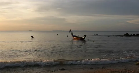 Fishing boat with person at sunset on ocean Koh Lanta island Thailand wide Stock Footage 58975853