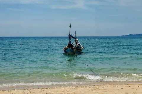 A fishing boat is pulling up on the beach Foto stock