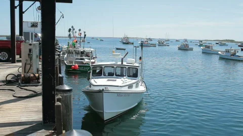 Fishing boat pulls away from dock Stock Footage 829525