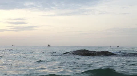 Fishing boat sailing across horizon Stock Footage