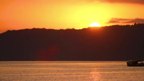 Fishing boat sailing down the river at sunset Stock Footage 131043833