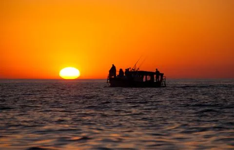Fishing boat at the sunset Stock Photos