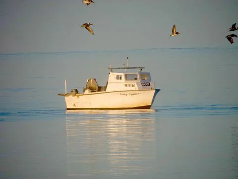 Fishing boat at sunset Stock Photos
