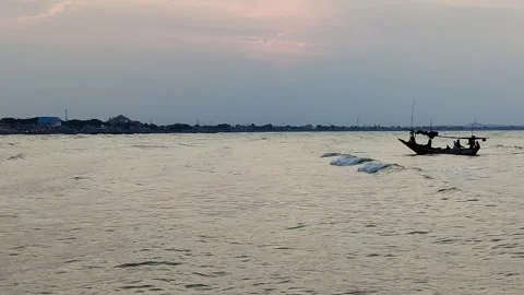 A fishing boat swayed by small waves heading towards the harbor Stock Footage 277516131