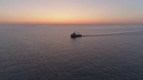 Fishing boat trawler catch fish and sailing on sea at sunset Stock Footage 162613607