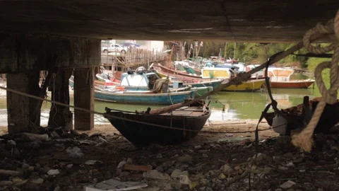 Fishing Boat Under Bridge on Polluted Shores, Sattahip, Thailand Stock Footage 120725928