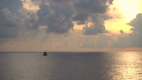 Fishing Boat View at Sunset time Ship Floats on Sea Surface Golden Sky Leaving a Stock Footage 155222032