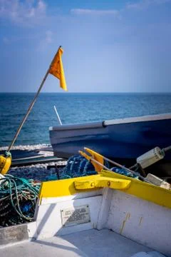 Fishing boat withe equipment and yellow flag Stock Photos