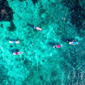 Fishing Boats and Snorkeling Tourists Stock Photos