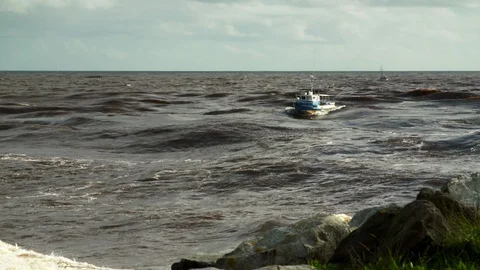 Fishing boats crossing river bar. Video stock 91665553