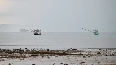 Fishing boats float offshore at Klong Muang Beach Stock Footage 336718024