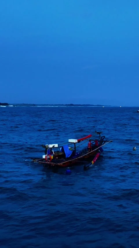 Fishing boats floating on deep blue twilight sea Stock Footage 335433060