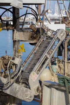 Fishing boats in harbor - machine for the processing of clams Stock Photos