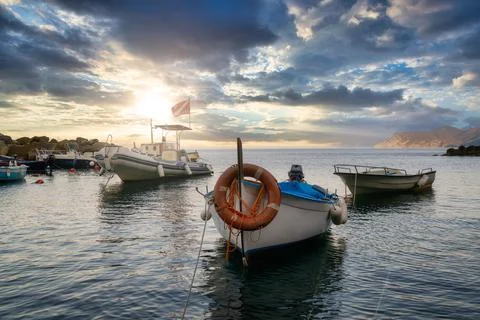 Fishing boats in a marina during a beautiful sunset Stock Photos