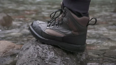 Fishing boot stepping onto rock Stock Footage 65068760