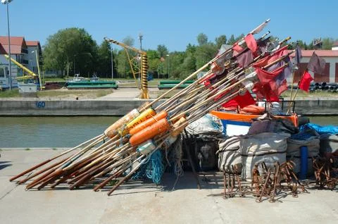 Fishing buoys on quay in small harbour Stock Photos