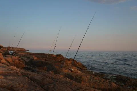 Fishing during the sunset Stock Photos