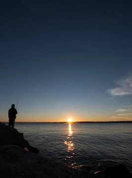 Fishing at dusk Stock Photos