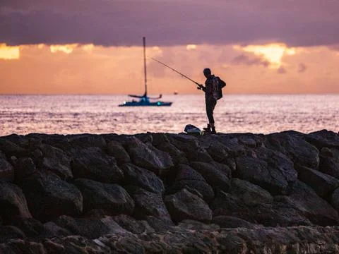 Fishing at dusk Stock Photos