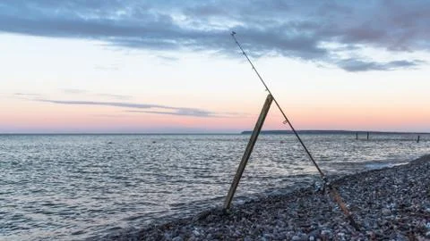 Fishing in the evening in the ocean Stock Photos