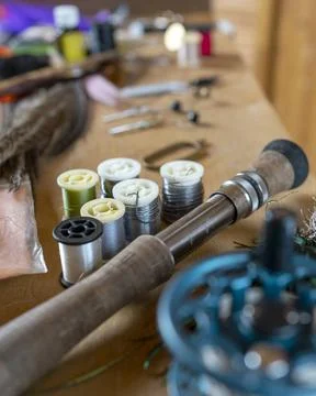 Fishing fly tying materials and tools on a wooden table Stock Photos