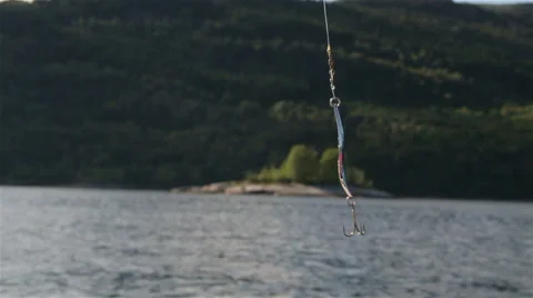 Fishing hook hanging from pole with moving sea Stock Footage 52998574