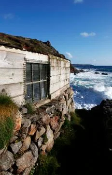 Fishing hut being battered by waves Stock Photos