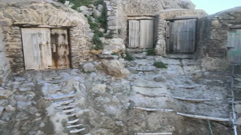 Fishing huts in the cliffs on Ibiza at Ses Balandres at sea Stock Footage 164154489