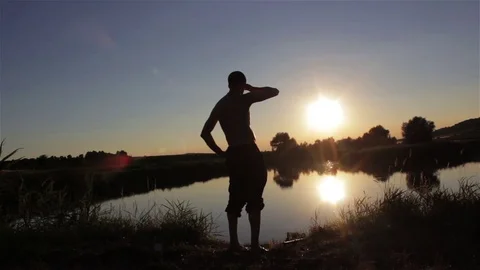 Fishing in the lake at sunset Stock Footage 72782326