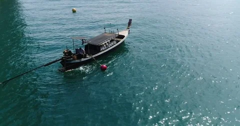 Fishing longtail made fast to a yellow mooring buoy 動画素材 71301308