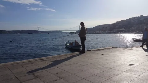 Fishing Man and Active Man Riding on Electric Scooter in City Stock Footage 126005143