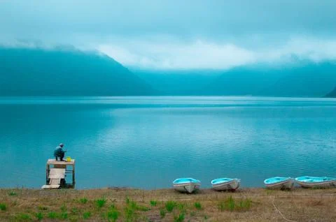 A Fishing man and boats at the Yamanashi Lake, Japan Stock Photos