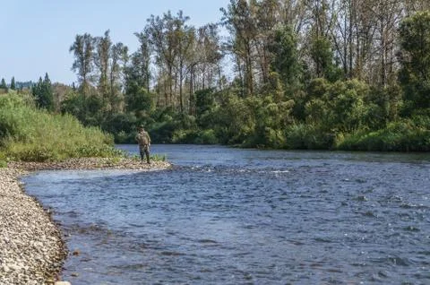 Fishing on the mountain river with fast current Foto stock