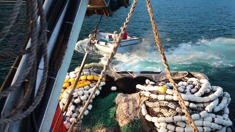 Fishing net being pulled into the sea by a motorboat Stock Footage 83180122