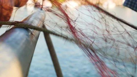 Fishing net close up, harbour workers at work. Fishermen arranging fishing nets Stock Footage 137864198