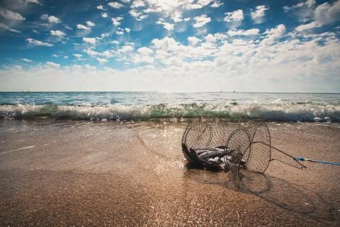 Fishing net coop trap , a floating basket for keeping live fish in water Stock Photos