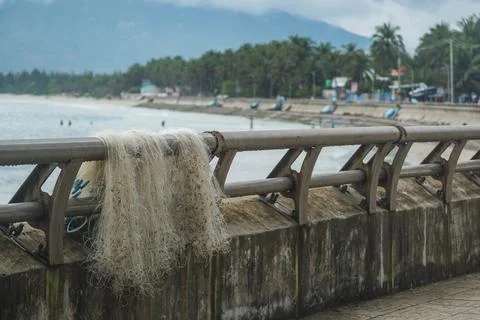 Fishing Net Drying on a Promenade Railing Fotos de archivo