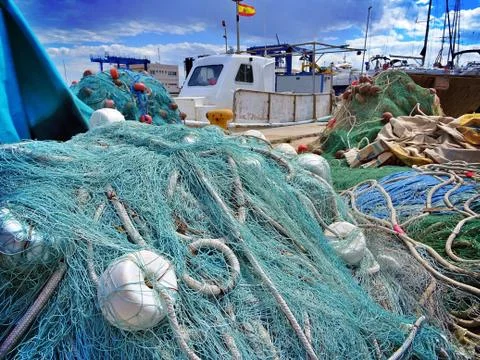 Fishing net drying in the sun over the Santa Pola harbor in Alicante Stock Photos