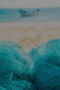 Fishing net placed on the sand beach Stock Photos