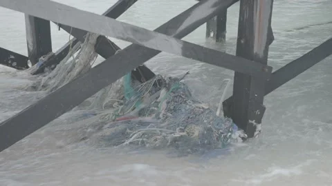 Fishing Net Pollution Caught Under Dock by Beach Stock Footage 159135305