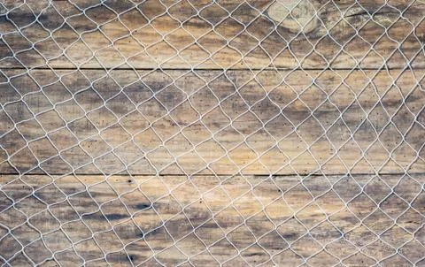 Fishing net on rustic old brown wood background Stock Photos