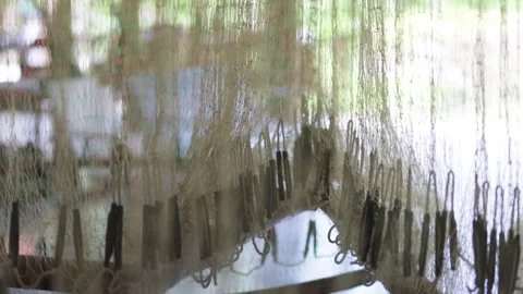 A fishing net serves as a decorative window hanging. Stock Footage 322045354