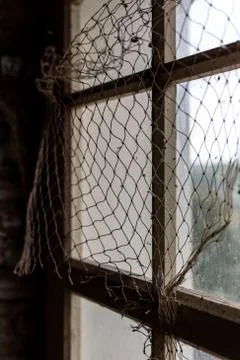 Fishing net on the window Stock Photos
