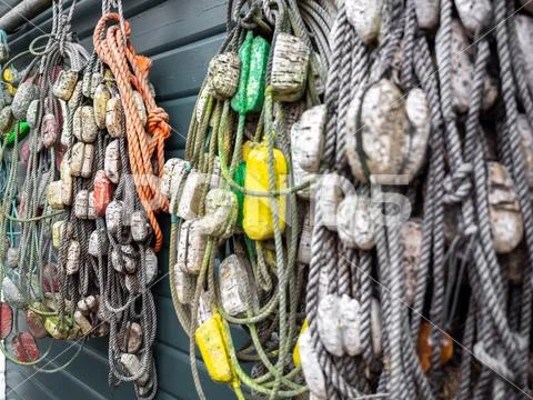 Fishing nets and ropes hang outside on the house wall Stock Photos