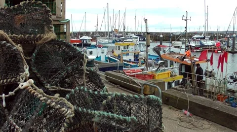 Fishing nets baskets boat harbour quay port jetty Stock Footage 49200939