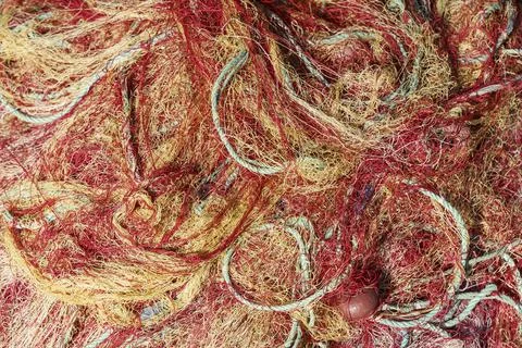 Fishing nets close up abstract background. Nylon fishing nets on a boat. Stock Photos