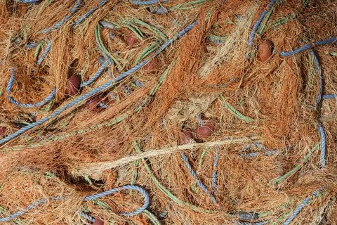 Fishing nets close up abstract background. Nylon fishing nets on a boat. Stock Photos