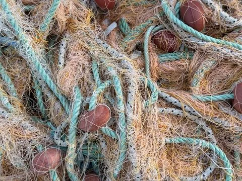 Fishing nets in closeup displaying ropes and floats, ideal for a nautical b.. Stock Photos