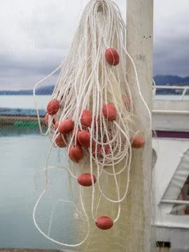 Fishing nets with floats on a pole. Drying networks. Fishing equipment. Stock Photos